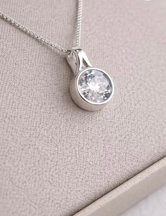 Secretly set silver round pendant