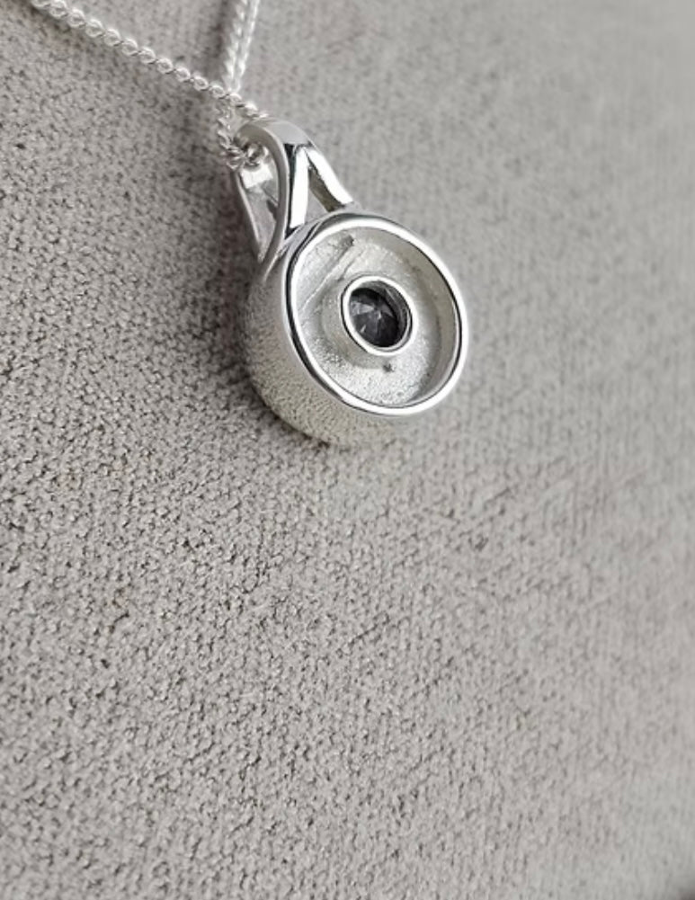 Secretly set silver round pendant