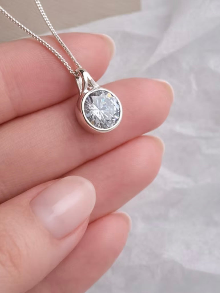 Secretly set silver round pendant